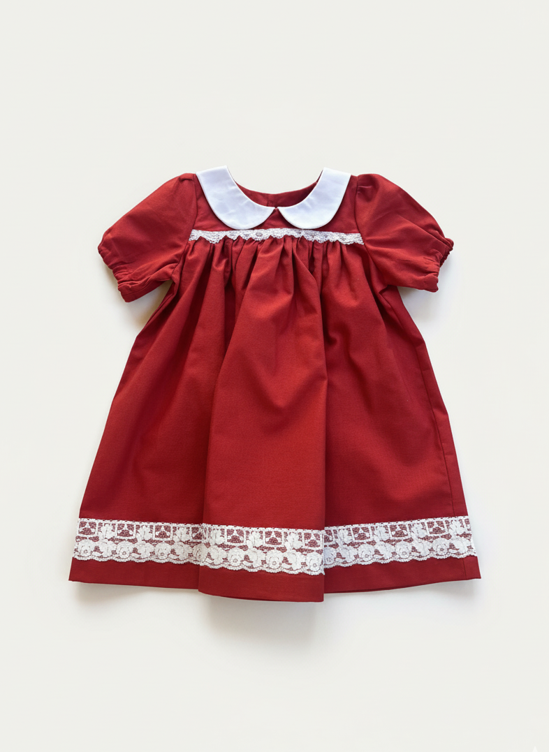 Red dress with white lace trim and collar on a light gray background
