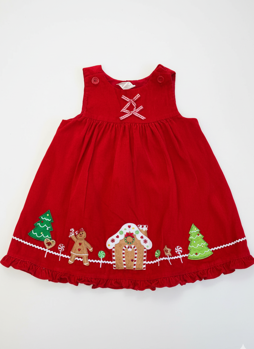 Red dress with Christmas-themed embroidery on a white background