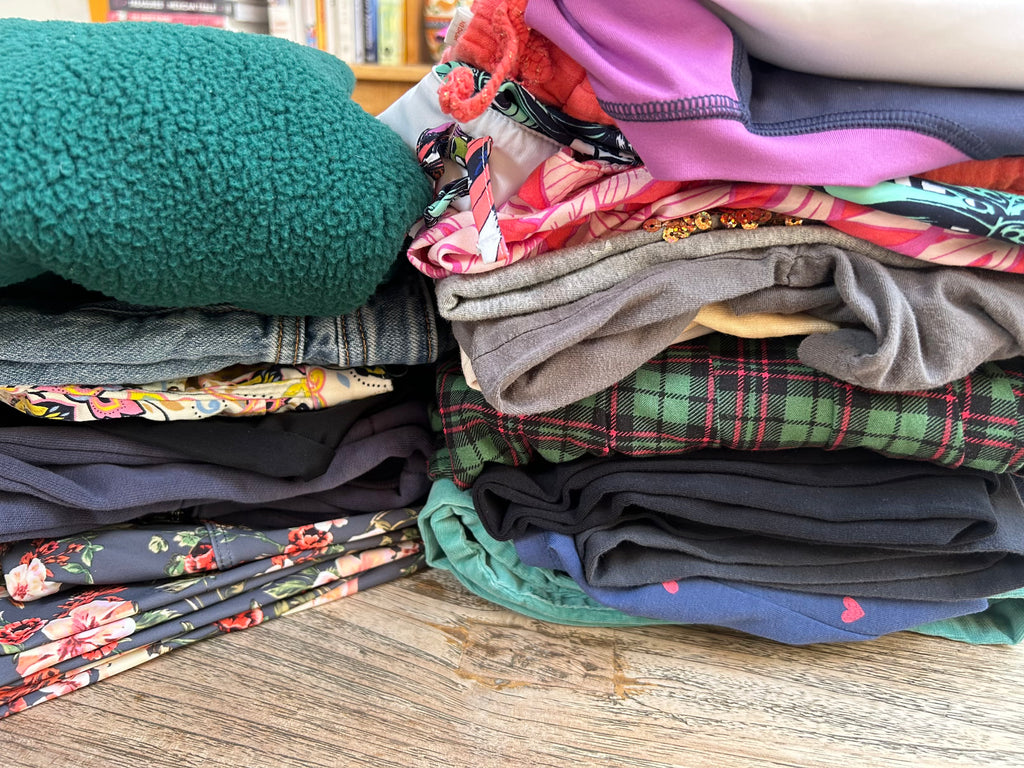 Stack of folded clothes on a wooden surface