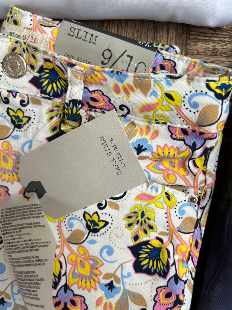 Colorful floral-patterned wallet with Zara label on a wooden surface