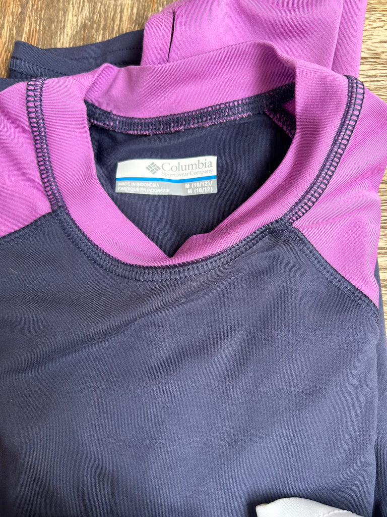 Purple and gray Columbia shirt on a wooden surface