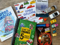 Children's books and toy cars on a wooden surface