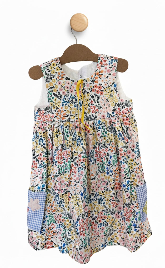 Floral dress on a wooden hanger against a white background