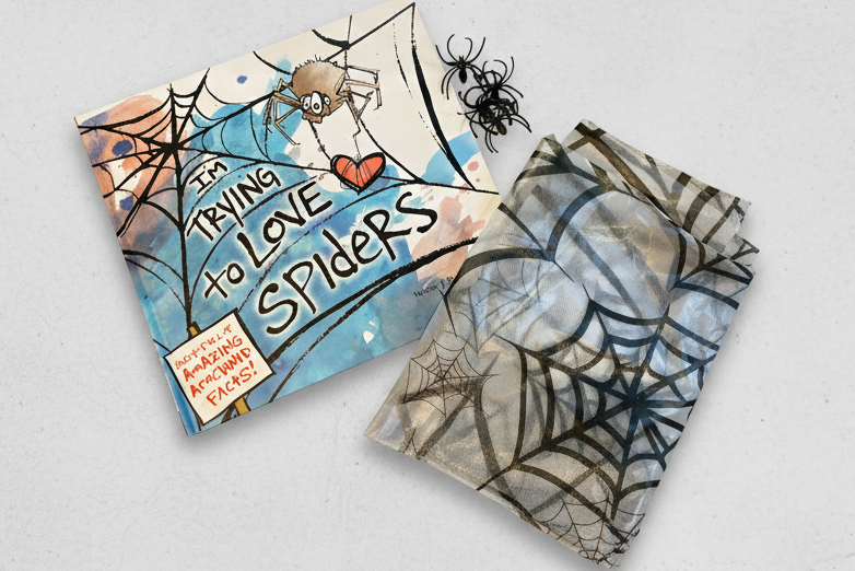 Spider book with plastic spiders and plastic tablecloth