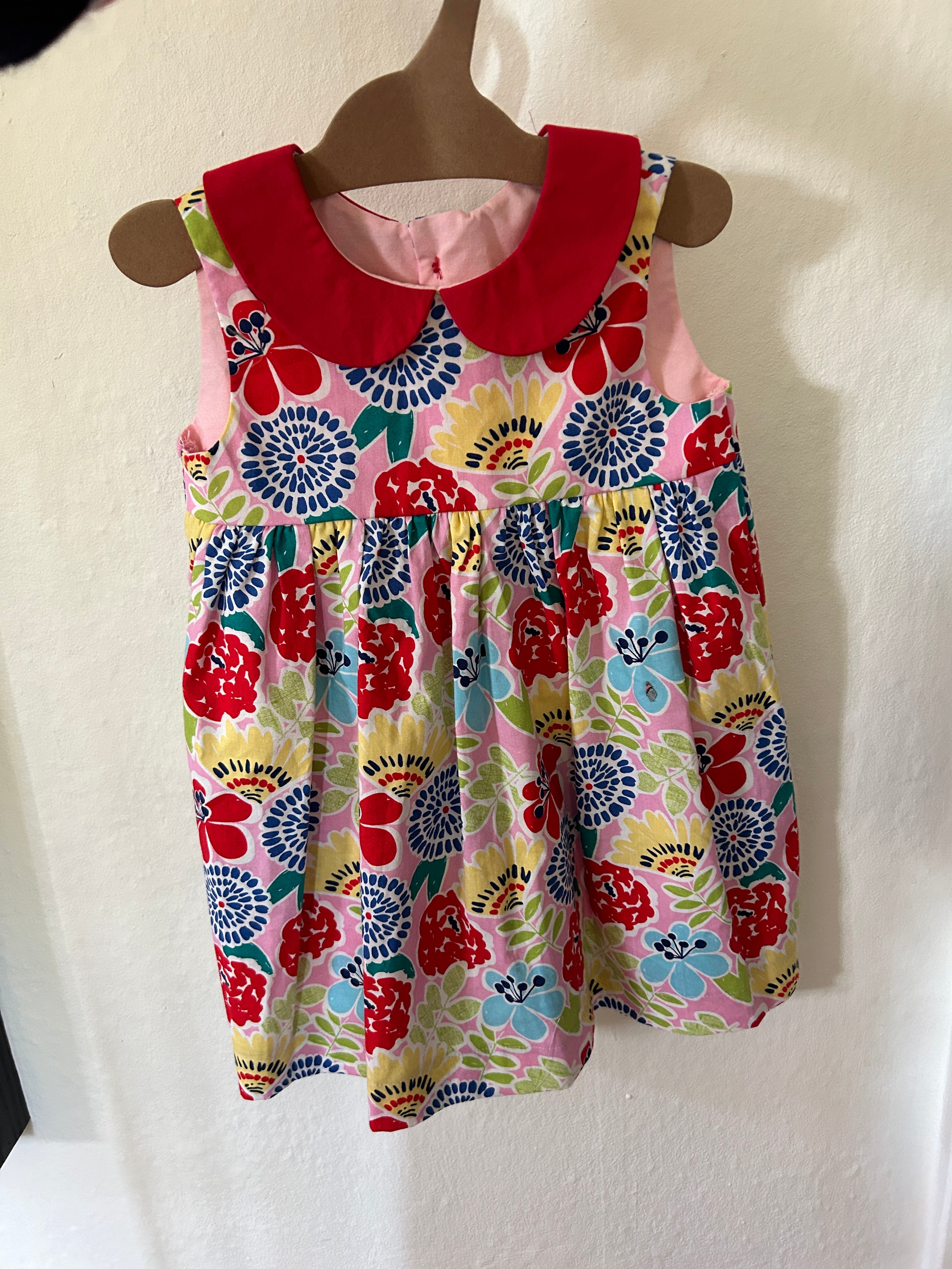 Floral dress with red accents on a white surface