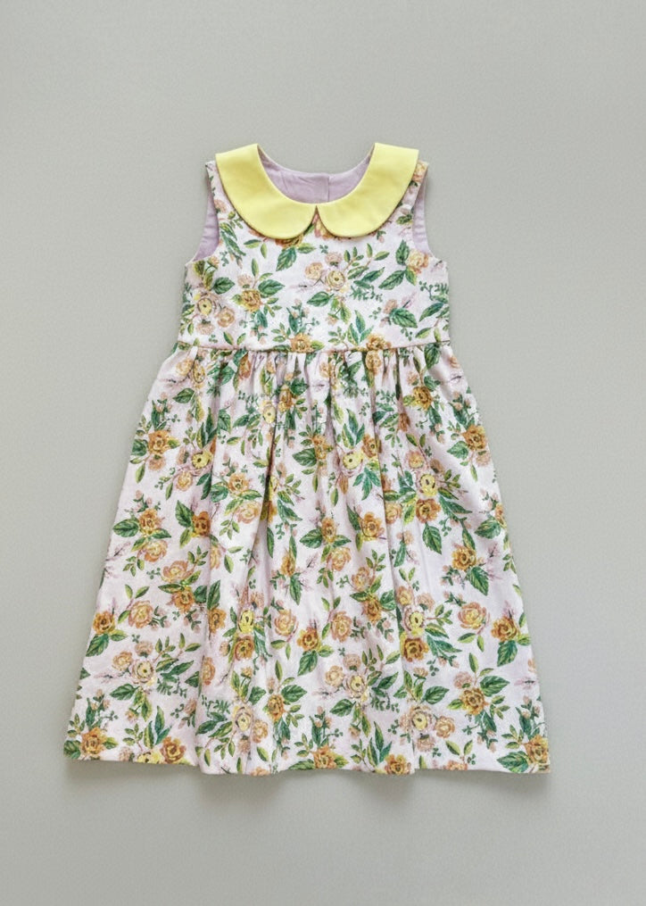 Floral dress with a yellow collar on a gray background