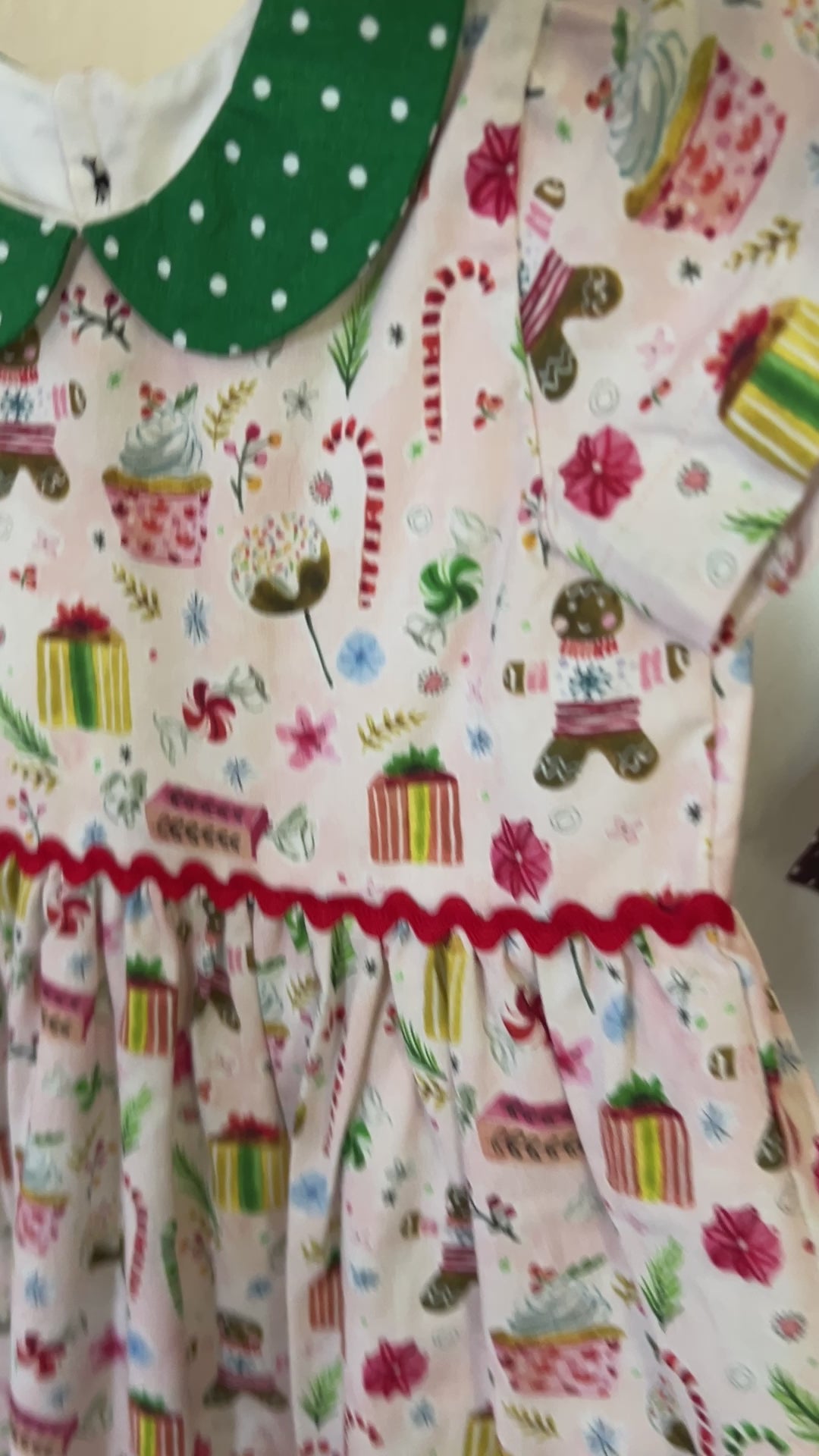 pink gingerbread dress with green dot peter pan collar moving around 