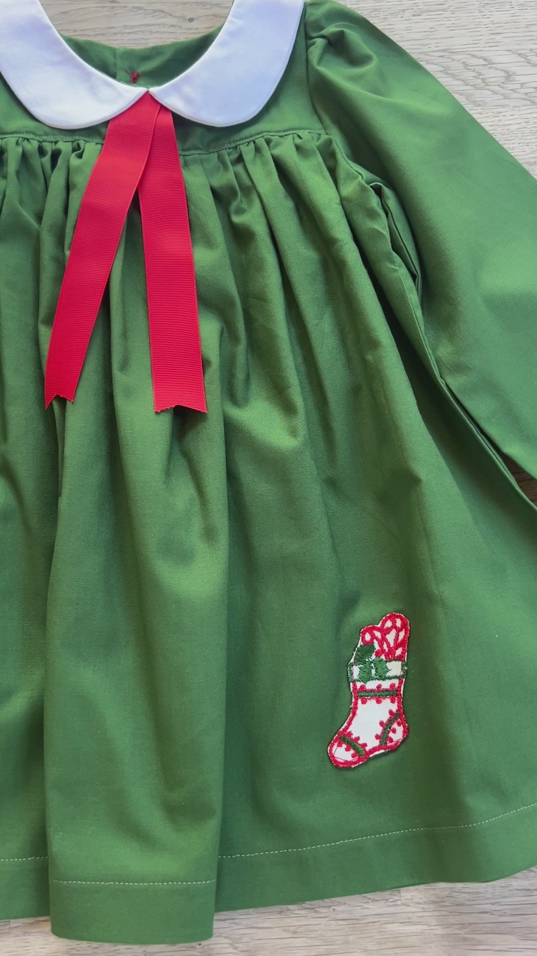 vintage style green dress with white peter pan collar and red ribbon and vintage applique stocking applied to dress