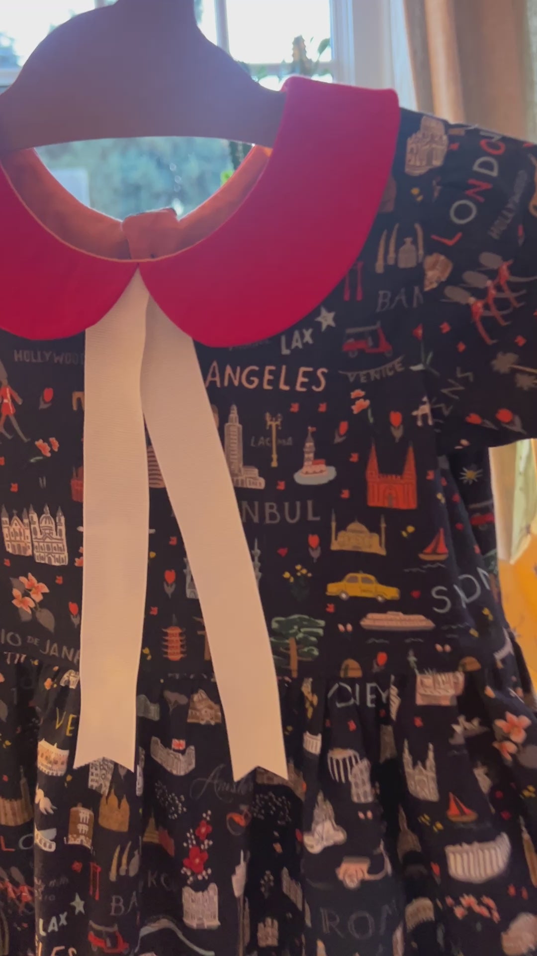 Little World Traveler Dress moving on a hanger