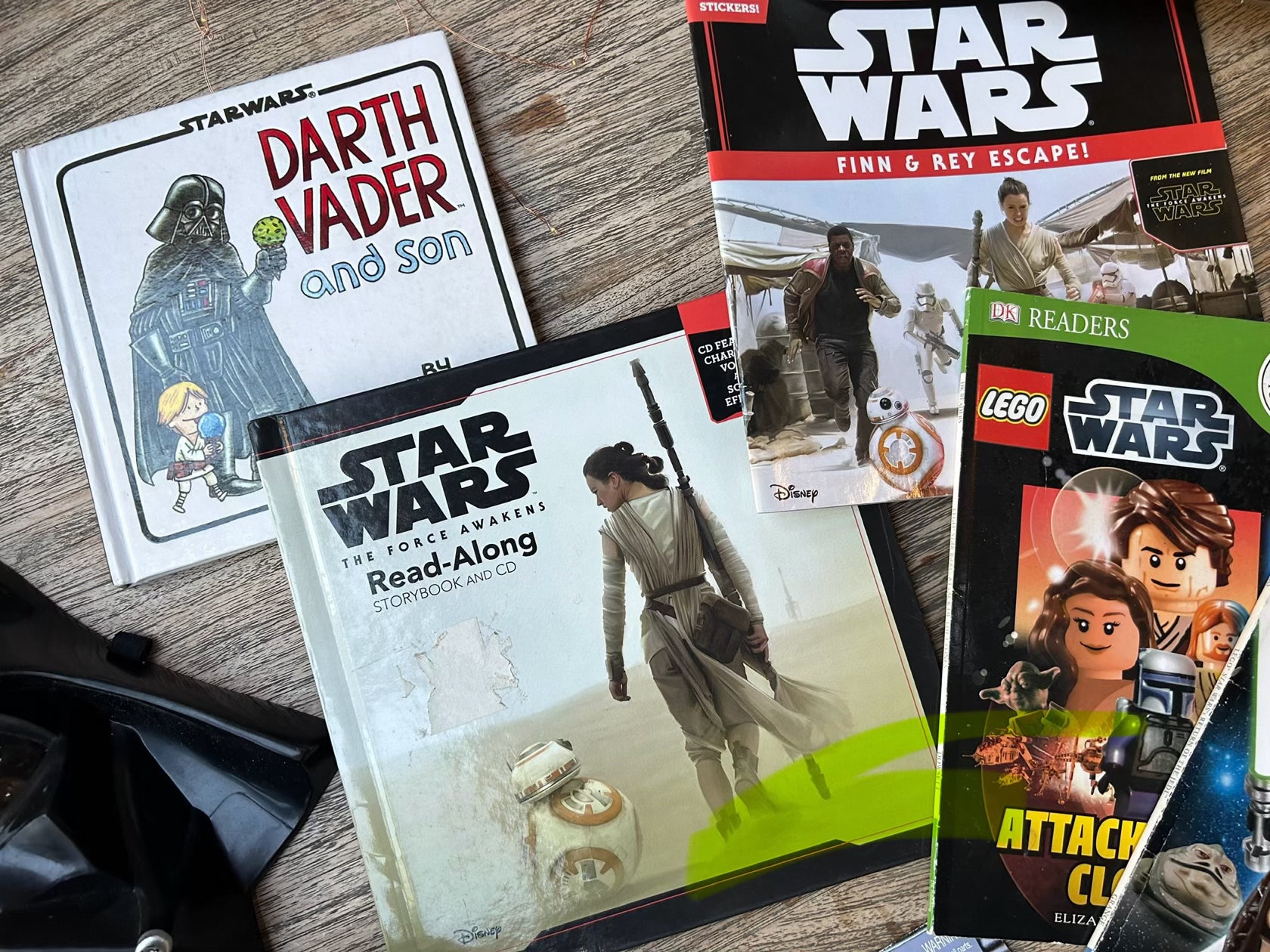 Collection of Star Wars books and readers on a wooden surface