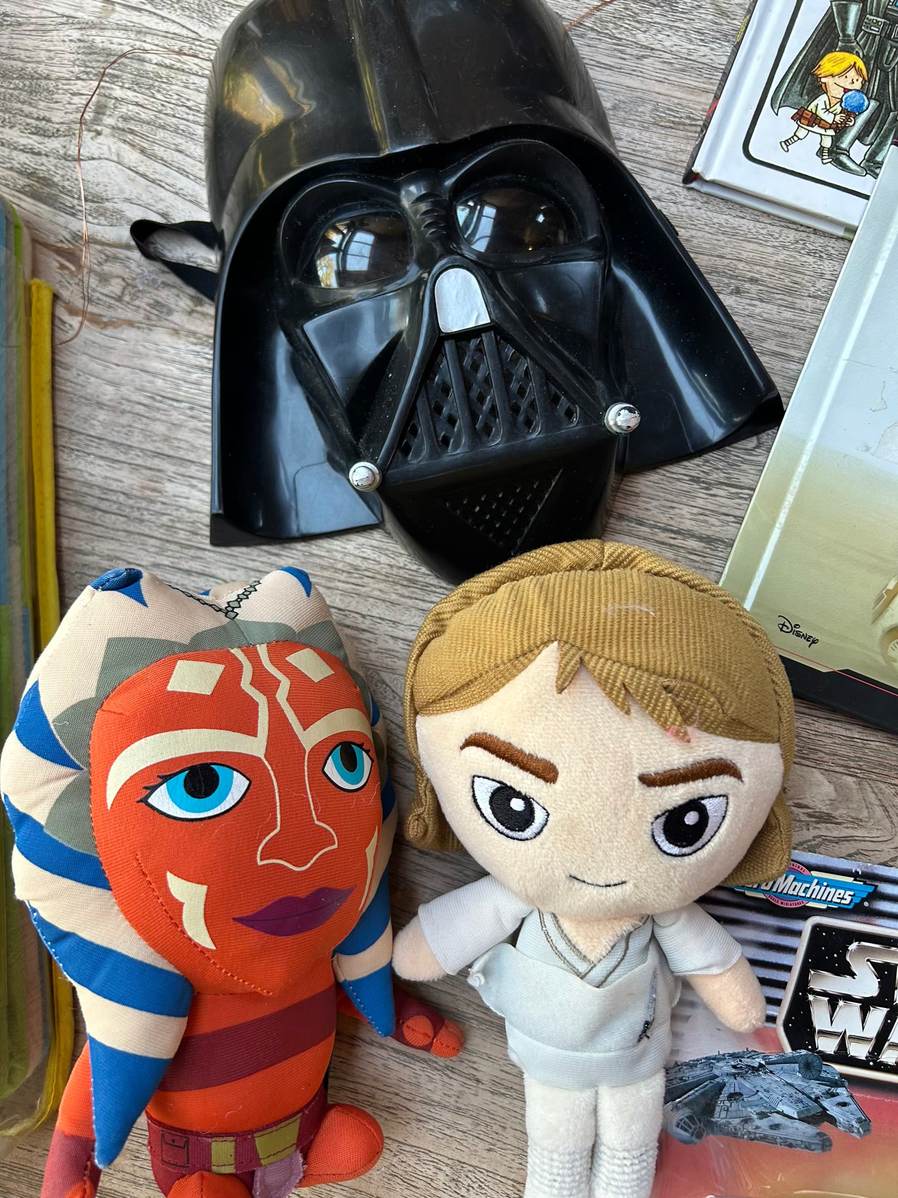 Plush toys resembling characters from a popular franchise on a wooden surface.