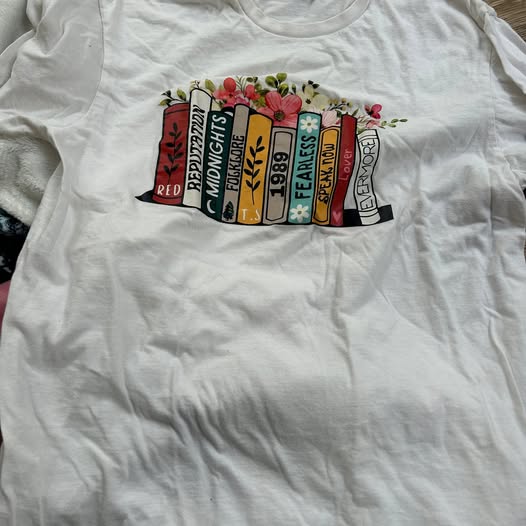 White t-shirt with colorful graphic design on a plain background