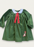 Green dress with red ribbon and white collar on a light gray background