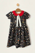 Children's dress with a red collar and black pattern on a white background