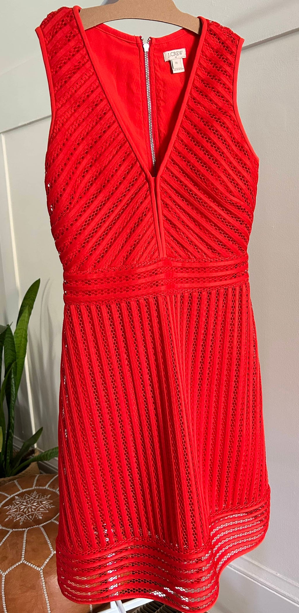 A red J-Crew eyelet dress displayed on a mannequin, featuring a V-neckline and 3/4 sleeves.