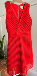 A red J-Crew eyelet dress displayed on a mannequin, featuring a V-neckline and 3/4 sleeves.